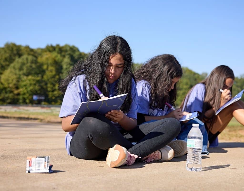 GOTR girls writing in their journals